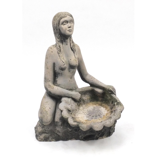 147 - Stoneware garden bird bath of a nude female holding a shell, 70cm high