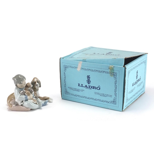 2280 - Lladro model of a young boy with his dog and four puppies, numbered 5456 with box, 12cm high