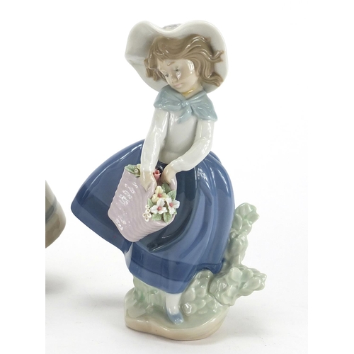 2283 - Three Lladro figurines including a girl with geese and a young girl holding a basket of flowers, the... 