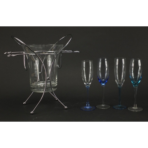 2083 - Stylish glass ice bucket, with stainless steel stand and four champagne flutes, overall 34cm high