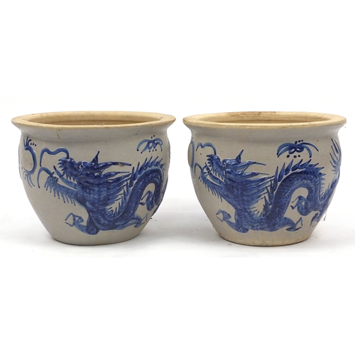 149 - Pair of stoneware planters, decorated with Chinese dragons, 33cm high x 44cm in diameter