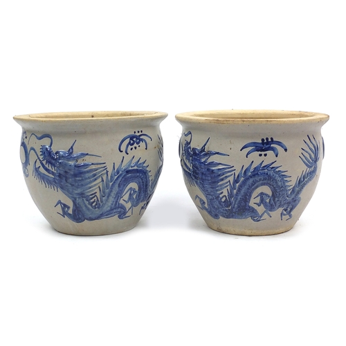 149 - Pair of stoneware planters, decorated with Chinese dragons, 33cm high x 44cm in diameter