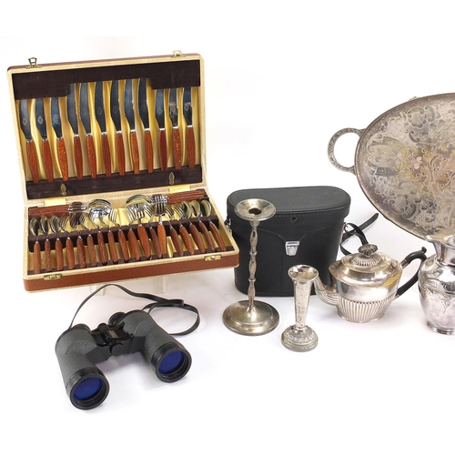 185 - Box of items including a silver plated teapot, candlesticks, cutlery and a pair of binoculars