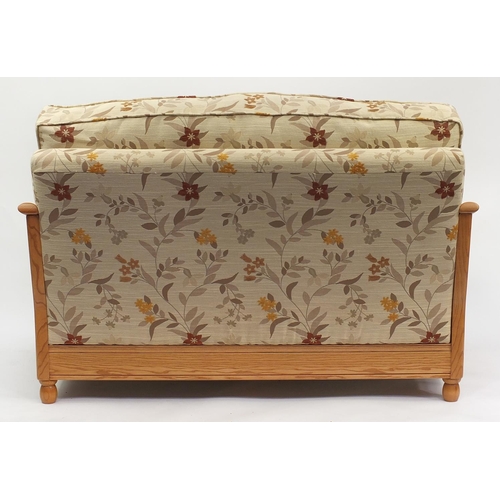 2013 - Ercol light elm bergere two seater settee with floral cushions, 95cm H x 137cm W x 104cm D