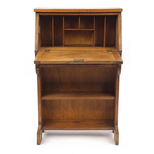 2026 - Arts & Crafts light oak student bureau, the fall enclosing a fitted interior, with stylised embossed... 
