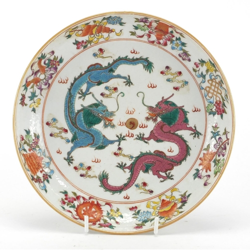 617 - Chinese porcelain shallow dish, hand painted in the famille rose palette with objects and two dragon... 