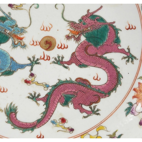 617 - Chinese porcelain shallow dish, hand painted in the famille rose palette with objects and two dragon... 