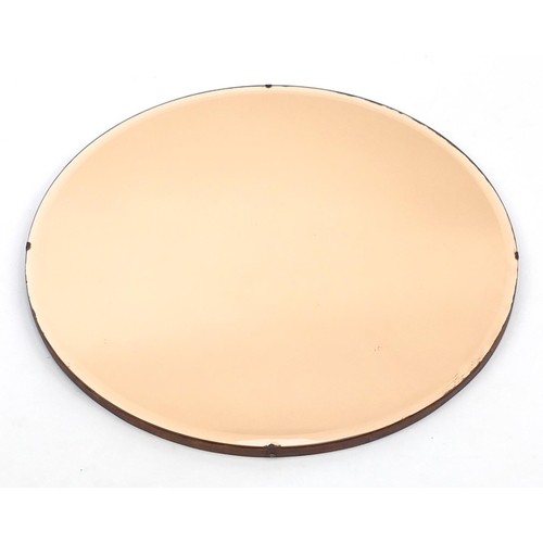 101 - Circular peach glass mirror with bevelled edge, 62cm in diameter