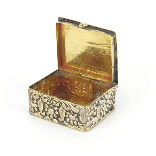 55 - 18th century rectangular unmarked silver and enamel pill box embossed with flowers, the hinged green... 