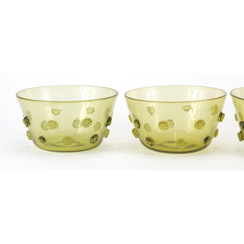 936 - Four Arts & Crafts green glass finger bowls, each 13.5cm in diameter