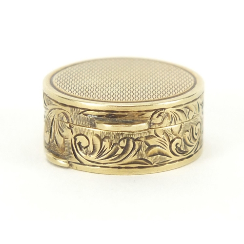 56 - Continental 14ct gold pill box with floral chased decoration, impressed mark around the inside rim, ... 