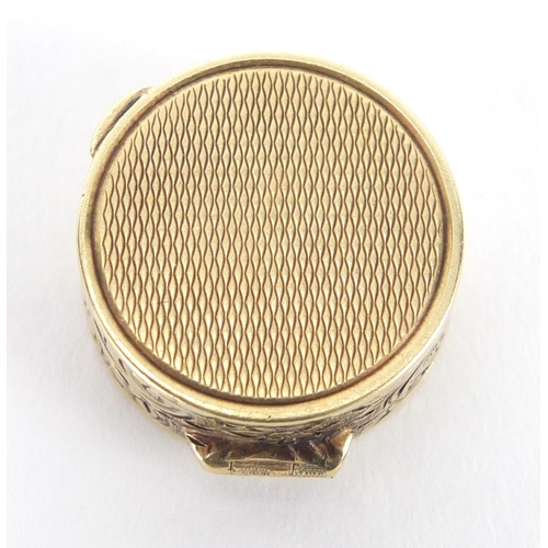 56 - Continental 14ct gold pill box with floral chased decoration, impressed mark around the inside rim, ... 