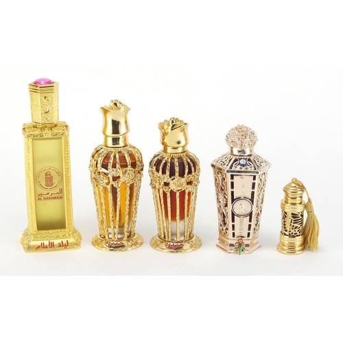 2075 - Five bottles of Al Haramain perfume, each bottle with an ornate case