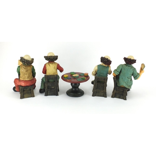 2222 - Hand painted set of four clowns playing cards around a table, the largest 24cm high