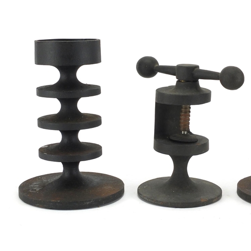 2176 - Pair of Robert Welch cast iron candlesticks and nutcracker, the largest 17.5cm high