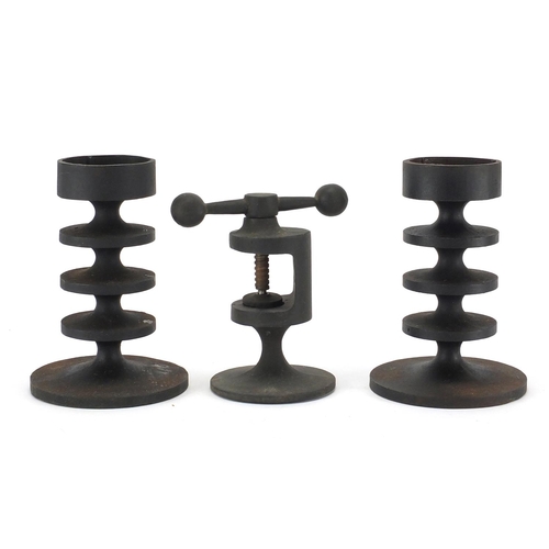 2176 - Pair of Robert Welch cast iron candlesticks and nutcracker, the largest 17.5cm high