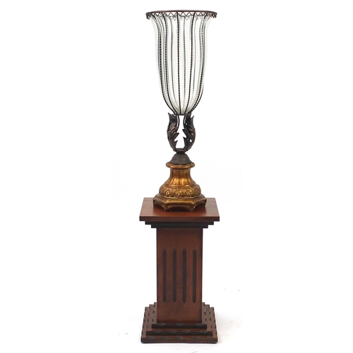 2118 - Wrought iron and glass vase on a square wooden pedestal, 103cm high