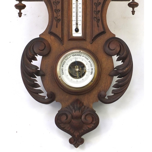 2053 - Carved wooden Black forest wall clock with thermometer and barometer, 90cm in length