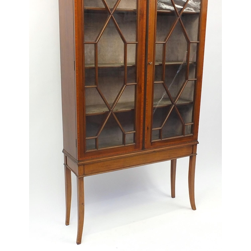 2023 - Edwardian inlaid mahogany bookcase, fitted with a pair of astragal glazed doors enclosing three shel... 