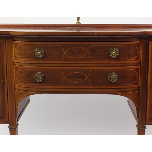 2043 - Late Victorian inlaid mahogany sideboard with brass backrail and a pair of bow fronted cupboard door... 
