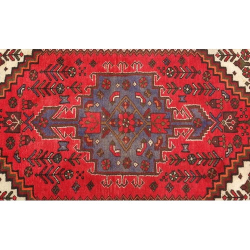 2032 - Rectangular Persian rug having an all over stylised floral design, 155cm x 102cm