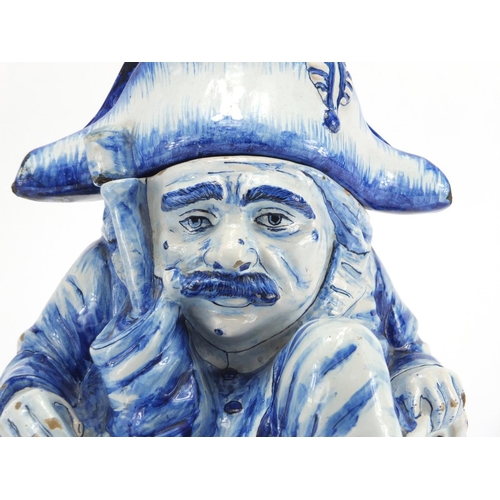 2242 - Delft blue and white pottery figural jar and cover, 27cm high