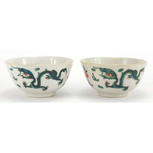 2304 - Pair of Chinese porcelain bowls, both hand painted in the famille verte palette with dragons amongst... 