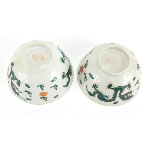 2304 - Pair of Chinese porcelain bowls, both hand painted in the famille verte palette with dragons amongst... 