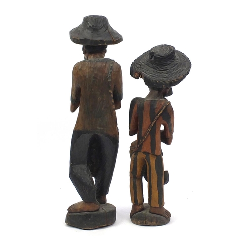 133 - Two large wood carvings both of African men, the largest 103cm high