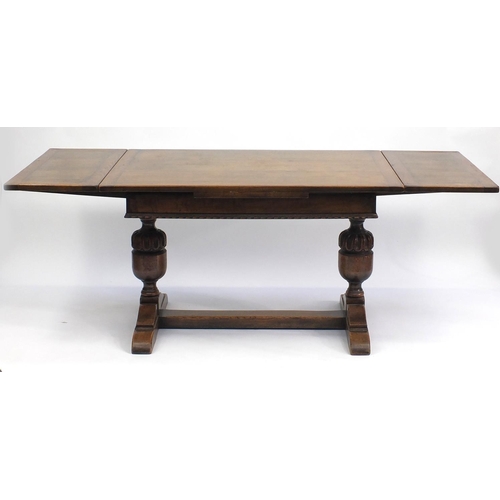 108 - Oak drawer leaf dining table with carved acorn legs, 76cm H x 122cm W x d81cm D