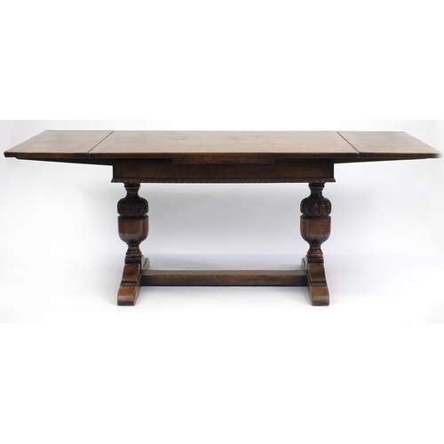 108 - Oak drawer leaf dining table with carved acorn legs, 76cm H x 122cm W x d81cm D