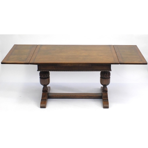 108 - Oak drawer leaf dining table with carved acorn legs, 76cm H x 122cm W x d81cm D