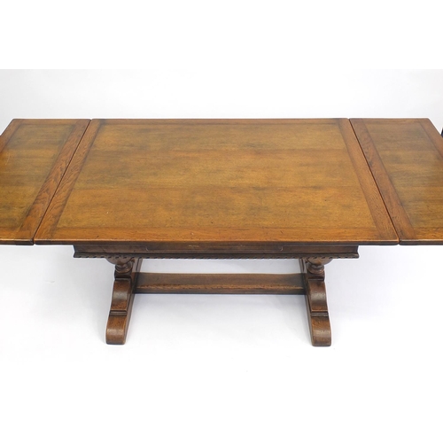 108 - Oak drawer leaf dining table with carved acorn legs, 76cm H x 122cm W x d81cm D