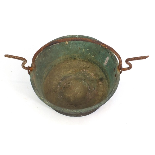 124 - Antique copper cauldron with swing handle, 51cm in diameter