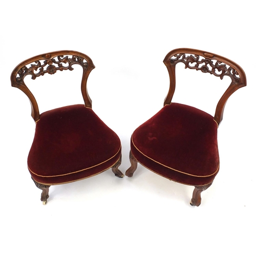 2 - Pair of carved walnut bedroom chairs with cabriole legs and ceramic castors, 70cm high