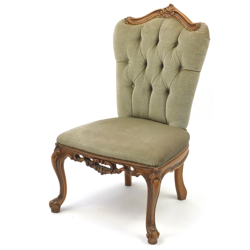 25 - Carved light wood framed bedroom chair, with green button back upholstery, 85cm high