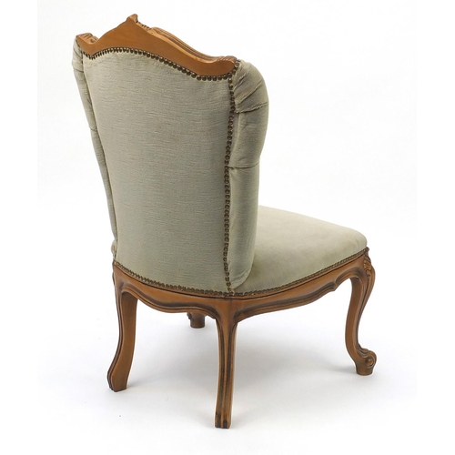 25 - Carved light wood framed bedroom chair, with green button back upholstery, 85cm high