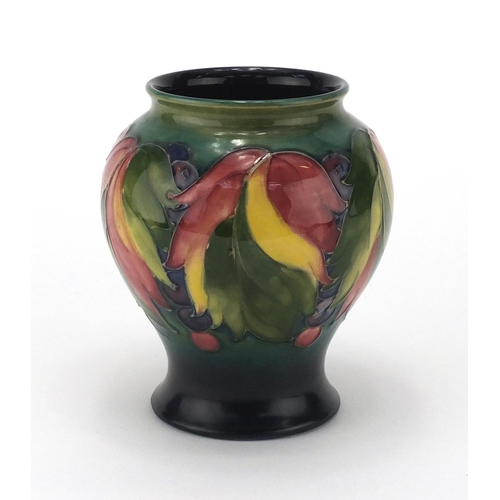 946 - Moorcroft leaf and berry pattern baluster vase, painted factory marks to the base, 15.5cm high