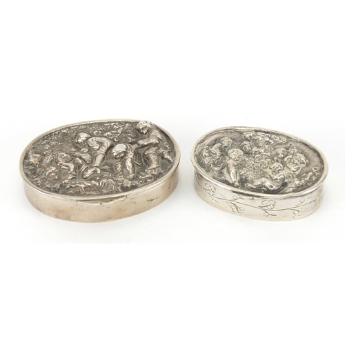 49 - Two oval continental silver snuff boxes, the hinged lids embossed with working children and cupids, ... 