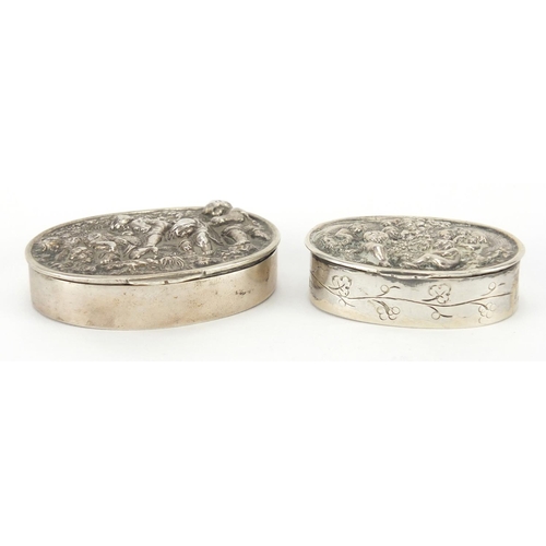 49 - Two oval continental silver snuff boxes, the hinged lids embossed with working children and cupids, ... 