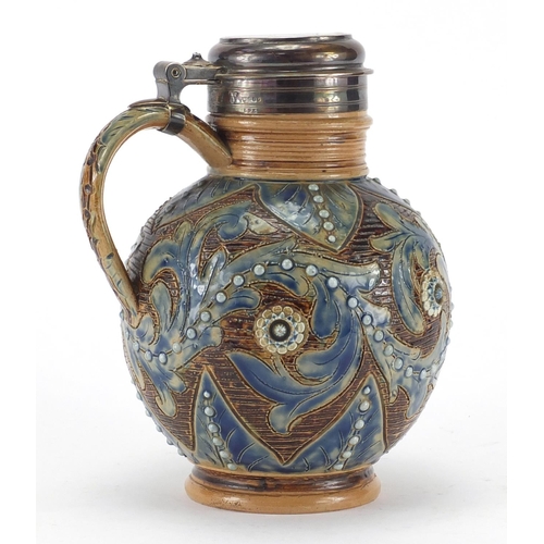 956 - Doulton Lambeth stoneware jug with silver lid and mounts, hand painted and incised with flower heads... 