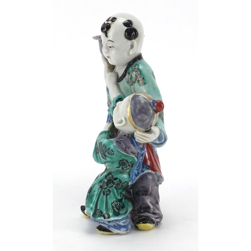 642 - Chinese porcelain figural candlestick, modelled as a father and child, hand painted in the famille v... 