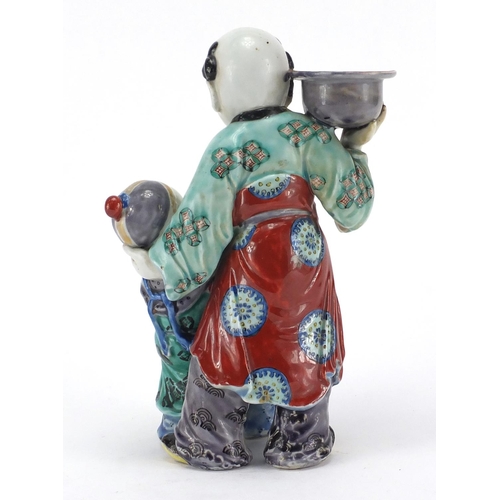 642 - Chinese porcelain figural candlestick, modelled as a father and child, hand painted in the famille v... 