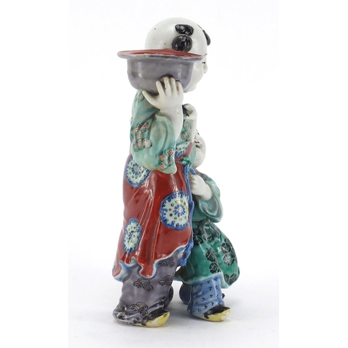 642 - Chinese porcelain figural candlestick, modelled as a father and child, hand painted in the famille v... 