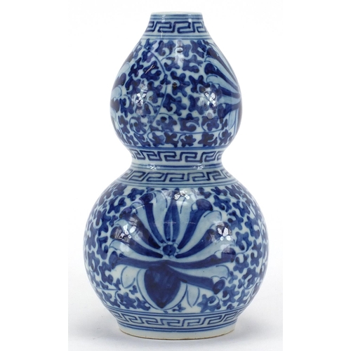 599 - Chinese blue and white porcelain double gourd vase, hand painted with blossoming flowers and foliage... 