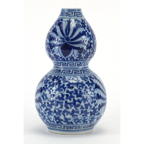 599 - Chinese blue and white porcelain double gourd vase, hand painted with blossoming flowers and foliage... 