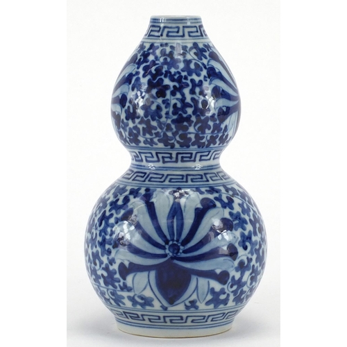 599 - Chinese blue and white porcelain double gourd vase, hand painted with blossoming flowers and foliage... 