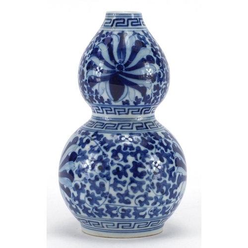 599 - Chinese blue and white porcelain double gourd vase, hand painted with blossoming flowers and foliage... 