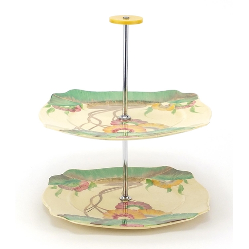 955 - Clarice Cliff Bizarre, two tier cake stand hand painted in the Aurea pattern, factory marks to the b... 