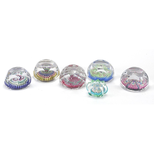 912 - Six colourful glass paperweights including a Whitefriars Christmas 1979 Millefiori paperweight, the ... 